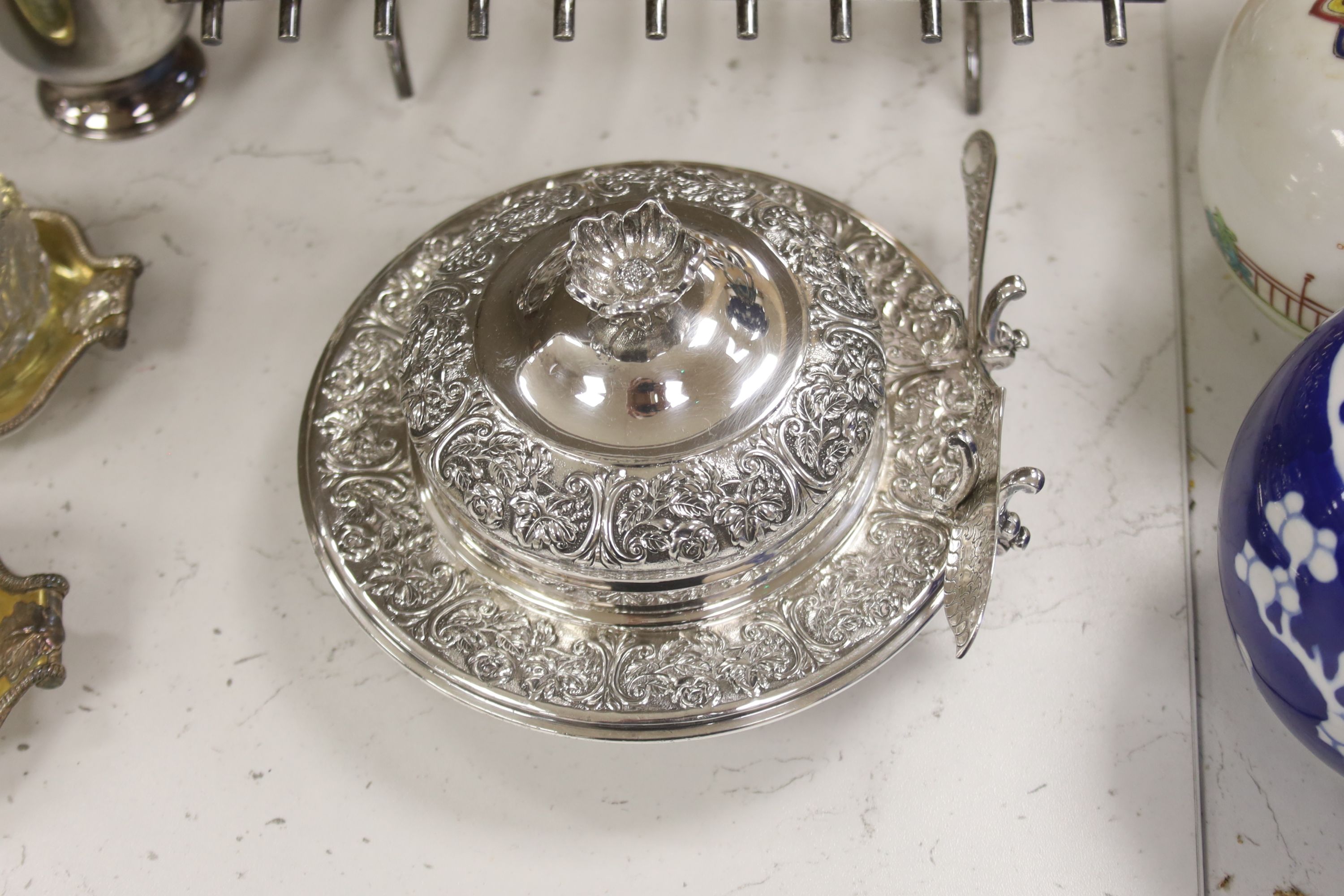 A group of assorted plated wares including a set of four gilt salts and a butter dish